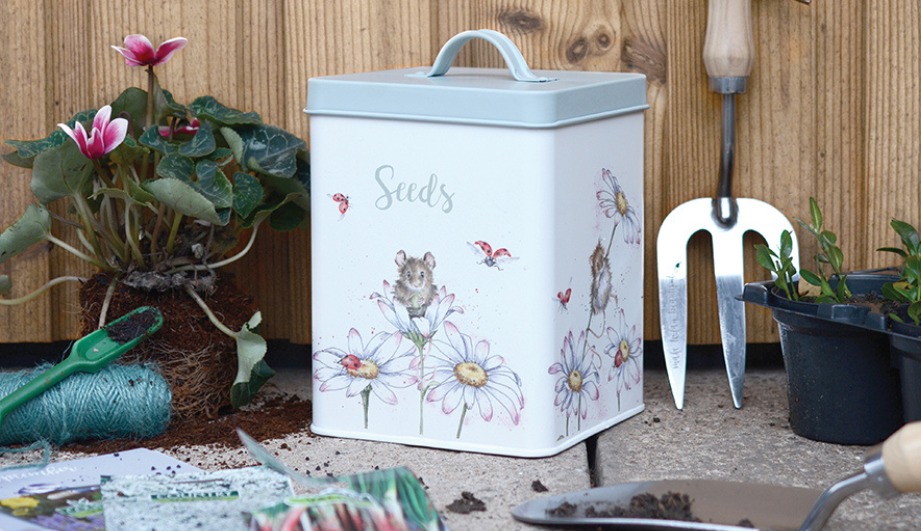 Forward facing lifestyle image of Wrendale Gifts and Gardening, Featuring the bird seed tin and trowel and fork set.