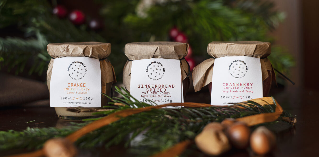 Lifestyle image of Festive Honey Gift Set, 3 x 120g jars of orange, cranberry & gingerbread honey.